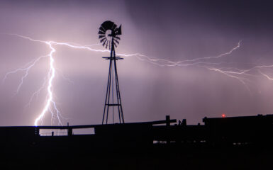 Lightning strikes behind a windmill in Western Oklahoma